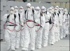  ?? AFP ?? South Korean soldiers arrive to spray disinfecta­nt at the Dongdaegu railway station in Daegu on Saturday.