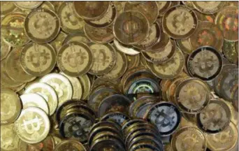  ?? RICK BOWMER — THE ASSOCIATED PRESS FILE ?? This file photo shows bitcoin tokens at a shop in Sandy, Utah.