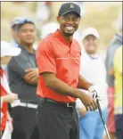  ?? Lynne Sladky / Associated Press ?? Tiger Woods smiles as he hits on the driving range before the final round at the Hero World Challenge golf tournament in Nassau, Bahamas on Dec. 4, 2016. Woods returns this week to the Hero World Challenge.