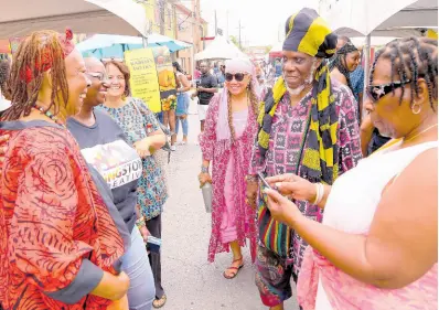  ?? CONTRIBUTE­D ?? From left: Artistic Director of Ntukuma, Dr. Amina Blackwood Meeks; Deputy Director of Kingston Creative Janet Crick; Board Director of Kingston Creative Doris Gross; fashion designer Jackie Cohen; and social commentato­r Mutabaruka, engage in dialogue alongside patrons at a recent staging of the Kingston Creative Artwalk Festival.