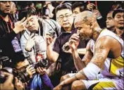  ?? JDS Sports / Slam ?? STEPHON MARBURY is surrounded by the media in Beijing in a scene from the moving documentar­y.