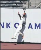  ??  ?? The Giants’ Wilmer Flores makes a leaping catch at thewall on a ball hit by the Rockies’ Charlie Blackmon during the fifth inning on Thursday in San Francisco.