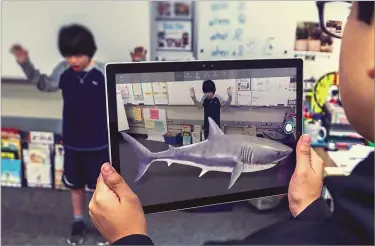  ??  ?? BELOW There’s a new Mixed Reality Viewer, but we can’t get as excited about it as this young man