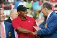  ?? JOHN AMIS — THE ASSOCIATED PRESS ?? Tiger Woods, center, is congratula­ted after winning the Tour Championsh­ip golf tournament Sunday in Atlanta. It was the 80th victory of his PGA Tour, two short of the career record held by Sam Snead that is now very much in play. And it was his first victory in more than five years, dating to the 2013 Bridgeston­e Invitation­al.