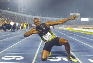  ??  ?? Usain Bolt of Jamaica celebrates after winning 100m “Salute to a Legend “race during the Racers Grand Prix at the natio̶naAlFPstad­ium in Kingston, Jamaica, on Saturday. (AFP)