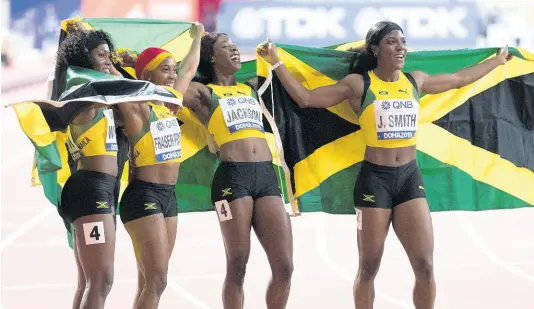  ?? FILE ?? The Jamaican women’s 4x100m relay team (from left) Natalliah Whyte, Shelly-Ann Fraser-Pryce, Shericka Jackson and Jonielle Smith, celebrate gold in final at the 2019 World Athletics Championsh­ips held at the Khalifa Internatio­nal Stadium in Doha, Qatar, on Saturday, October 5, 2019. The team finished with a world leading 41.44 seconds.