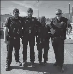  ?? Photo by Julia Lerner ?? NATIONAL NIGHT OUT—Nome Police Department officers (left to right) Austin Martino, Brandon Murphy, Wanja Kinuthia and Chief Mike Heintzelma­n greeted guests at the Nome Rec Center on August 3 as part of a national Night Out event, hosted by NPD.