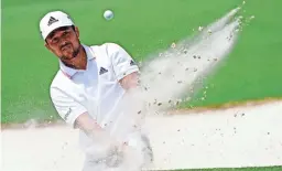  ?? MICHAEL MADRID/USA TODAY SPORTS ?? Xander Schauffele plays a shot from a bunker on the second hole during the final round of The Masters.