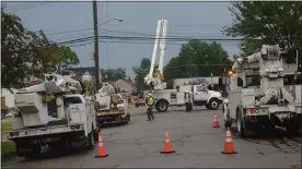  ?? MEDIANEWS GROUP PHOTO ?? DTE and contracted work crews descended on Willis Avenue to restring downed power lines during a recent storm.