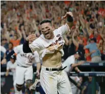  ?? Associated Press ?? Houston Astros' Jose Altuve reacts after scoring the game-winning run during the ninth inning of Game 2 of baseball's American League Championsh­ip Series against the New York Yankees
on Saturday in Houston. The Astros won, 2-1, to take a 2-0 lead in...