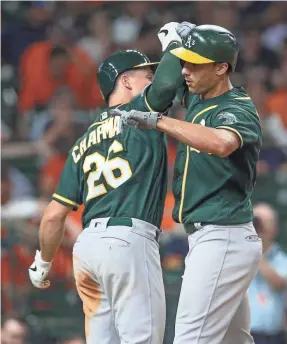  ?? THOMAS SHEA/USA TODAY SPORTS ?? Matt Chapman and Matt Olson celebrated more than a home run in 2019 as the 97-65 Athletics made it to the AL wild-card game.