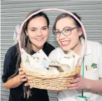  ??  ?? Smiles Becky Russell and Iona Halford sell the cakes to raise funds for SNAP