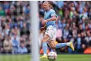  ?? ?? Erling Haaland slides home Manchester City’s opening goal against Brighton. Photograph: Robbie Jay Barratt/AMA/Getty Images