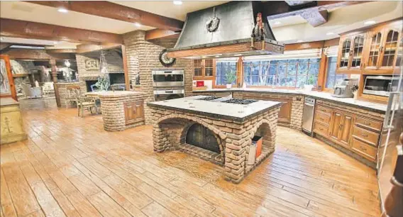  ?? Photograph­s courtesy of Rodeo Realty ?? BEFORE: Brick walls were a dominant feature in the original property, but in the kitchen, they were “tough to look at.”