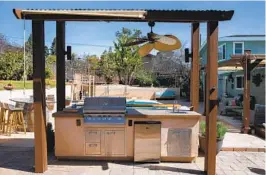  ?? ADRIANA HELDIZ U-T PHOTOS ?? The remodeled outdoor kitchen, built on concrete pavers near the pool, features a Lion Premium grill. A pergola built by the homeowners provides shade.