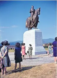  ?? ?? Statue Visitors observing the sculpture in the 1960s