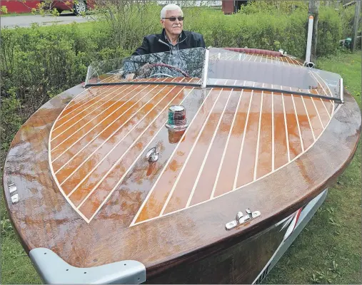  ?? CAPE BRETON POST ?? Don Rowe sits in the cockpit of Rowe’s Wood, the 19-foot mahogany runabout powerboat he built in the garage of his Sydney River home.