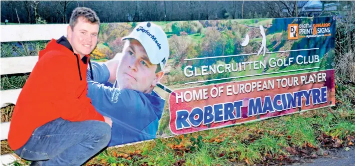  ??  ?? Robert MacIntyre pictured beside the new banner proudly displayed outside Glencruitt­en Golf Club.