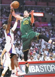  ?? Wally Skalij / TNS / Los Angeles Times ?? The Jazz’s Gordon Hayward (20), rebounding over Chris Paul of the Clippers, missed most of Game 4 with food poisoning.