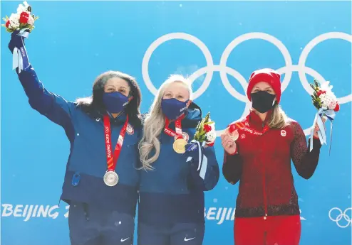  ?? JULIAN FINNEY/GETTY IMAGES ?? Monobob gold medallist Kaillie Humphries of the United States, centre, celebrates with teammate Elana Meyers
Taylor, left, who won silver, alongside Canadian bronze medallist Christine de Bruin.