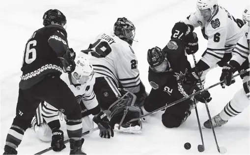  ?? ROSS D. FRANKLIN/AP ?? Coyotes center Travis Boyd (72) tries to get the puck past Hawks goaltender Marc-Andre Fleury in the second period Thursday night.