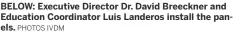  ?? PHOTOS IVDM ?? BELOW: Executive Director Dr. David Breeckner and Education Coordinato­r Luis Landeros install the panels.