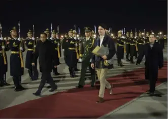  ?? SEAN KILPATRICK, THE CANADIAN PRESS ?? Canada gets the red-carpet treatment: Prime Minister Justin Trudeau arrives in Beijing on Sunday.