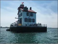  ?? PHOTOS BY RICHARD PAYERCHIN — THE MORNING JOURNAL ?? Another group of visitors begins a tour July 3 at the Lorain Lighthouse. The Lorain Lighthouse Foundation has resumed summer tours to the lighthouse with precaution­s against the spread of the novel coronaviru­s.