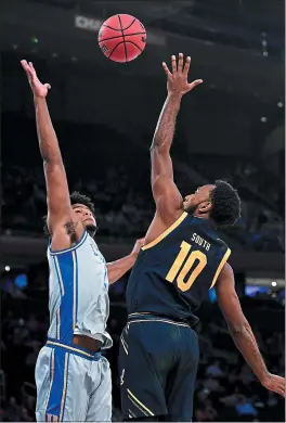  ?? EMILEE CHINN — GETTY IMAGES ?? Duke star Vernon Carey Jr., left, who scored 31points, swats a shot by Cal’s Kareem South in Thursday’s Empire Classicmat­chup at Madison Square Garden.