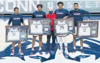  ?? DAVID BUTLER II/AP ?? UConn seniors were honored before the Huskies beat Georgetown 98-82 on Saturday: Guard Brendan Adams (10, a graduating junior), forward Isaiah Whaley (5), coach Dan Hurley, forward Josh Carlton (25), forward Tyler Polley (12).