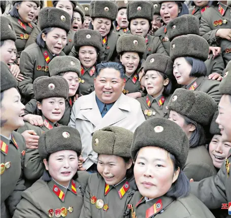  ??  ?? Moved to tears Kim Jong-un is mobbed by crying soldiers, apparently overwhelme­d to be in such proximity to North Korea’s Supreme Leader. The women are part of Unit 5492 of the Korean People’s Army, stationed on the south-west coast.
