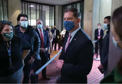  ?? POOL PHOtO ?? NOT TALKING: Mayor Martin Walsh stops to speak to the media briefly after giving a coronaviru­s update on Friday, but was still not talking about his expected new job as secretary of Labor.