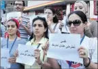  ?? Women hold signs asking for respect. Photo by U.N. Women ??