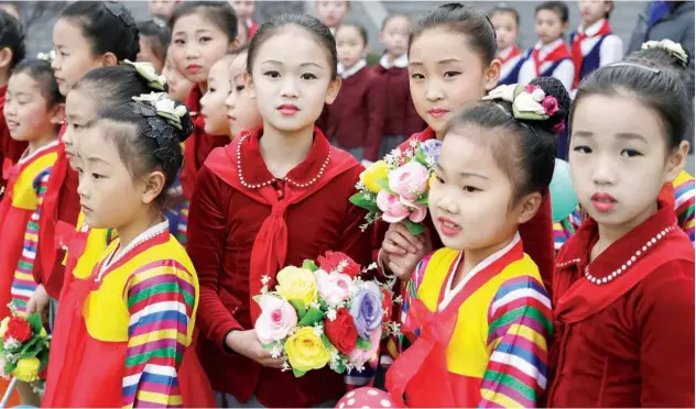  ?? Associated Press ?? North Korean girls wait for their turn to perform a dance during the election day at a polling station in Pyongyang on Sunday.
