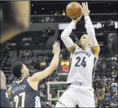  ?? Brandon Dill The Associated Press ?? Findlay Prep product Dillon Brooks lines up a shot over Nuggets guard Jamal Murray in the second half of the Grizzlies’ 101-94 win Saturday at FedExForum.