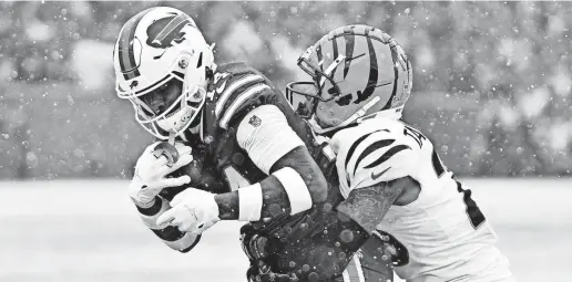  ?? MARK KONEZNY/USA TODAY SPORTS ?? Bills wide receiver Stefon Diggs is stopped by Bengals cornerback Cam Taylor-Britt.