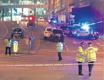  ??  ?? Aftermath of the carnage as police cordon off streets around the arena