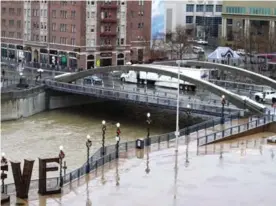  ??  ?? In this Jan 4, 2017, file photo, traffic crosses the Virginia Street bridge in downtown Reno, Nevada above the rising waters of the Truckee River, where a flash flood watch was in effect. The bridge built last year replaced a century-old one where...