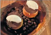  ?? Photo: Gert Top ?? Choux pastries with coconut ice, black chocolate and cream.