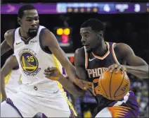  ?? Ben Margot ?? The Associated Press Golden State’s Kevin Durant, left, checking Phoenix’s Josh Jackson on Monday in Oakland, Calif., is the reigning NBA Finals MVP.