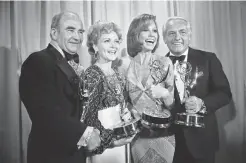  ?? The Associated Press ?? Cast members of the “Mary Tyler Moore Show” pose with their Emmys backstage at the 28th annual Emmy Awards in Los Angeles in this May 18, 1976, file photo. From left are Ed Asner, Betty White, Mary Tyler Moore and Ted Knight.