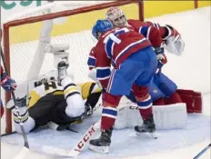  ?? Associated Press ?? Canadiens defenseman Brett Kulak (77) drives Sidney Crosby into the back of the net in the second period.