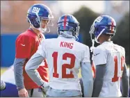  ?? Howard Simmons / TNS ?? Giants quarterbac­k Eli Manning, left, talks with wide receivers Tavarres King and Travis Rudolph during practice Wednesday in East Rutherford, N.J.