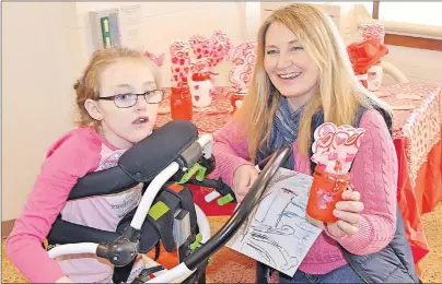  ?? ERIC MCCARTHY/TC MEDIA ?? Charlene Merriam and her daughter Chakyra examine art pieces up for sale during Bloomfield Elementary School’s seventh annual Heart Art Day on Tuesday.