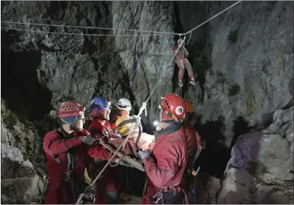  ?? AFAD - VIA THE ASSOCIATED PRESS ?? American researcher Mark Dickey, above center, is pulled out of Morca cave near Anamur, south Turkey, early Tuesday, more than a week after he became seriously ill more than 3,000 feet below its entrance. Teams from across Europe had rushed to Morca cave in southern Turkey’s Taurus Mountains to aid Dickey, left, a 40-year-old experience­d caver who became seriously ill on Sept. 2 with stomach bleeding.