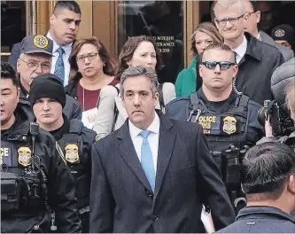  ?? CHANG W. LEE NEW YORK TIMES ?? Michael Cohen, centre, leaves federal court after his sentencing in Manhattan. He had told the judge: “It was my own weakness and a blind loyalty to this man (Trump) that led me to choose a path of darkness over light.”