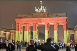  ?? AFP ?? BERLIN: The Brandenbur­g Gate is seen in the colors of the German flag in Berlin on December 20, 2016 one day after a truck crashed into a Christmas market. —