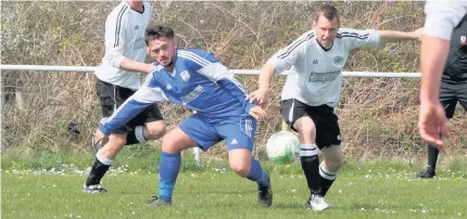  ??  ?? Trearddur Bay United (blue) take on Pwllheli