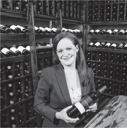  ?? Photos by Steve Gonzales / Staff photograph­er ?? Vanessa Treviño Boyd, the sommelier at The Houstonian Hotel, Club &amp; Spa, oversees the wine room of the new Tribute restaurant.