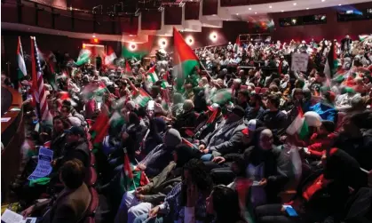  ?? ?? Attendees wave flags and fly signs during a rally in support of Palestine in Dearborn, Detroit on 10 October 2023. Photograph: Matthew Hatcher/AP